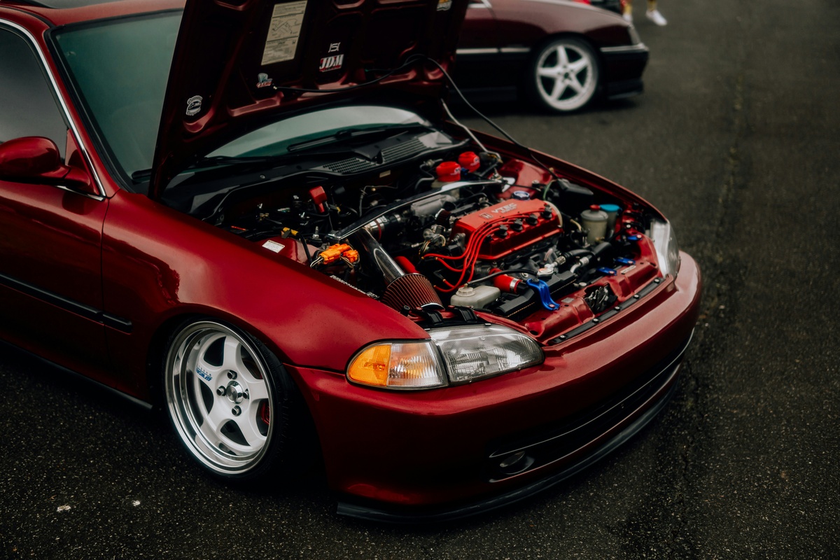 red car with its hood open